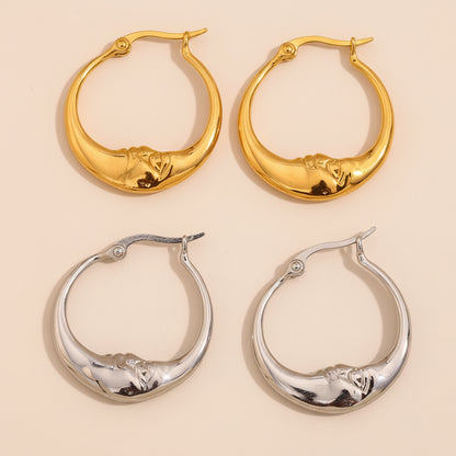 Two pairs of hoop earrings, one gold and one silver, on a beige background.