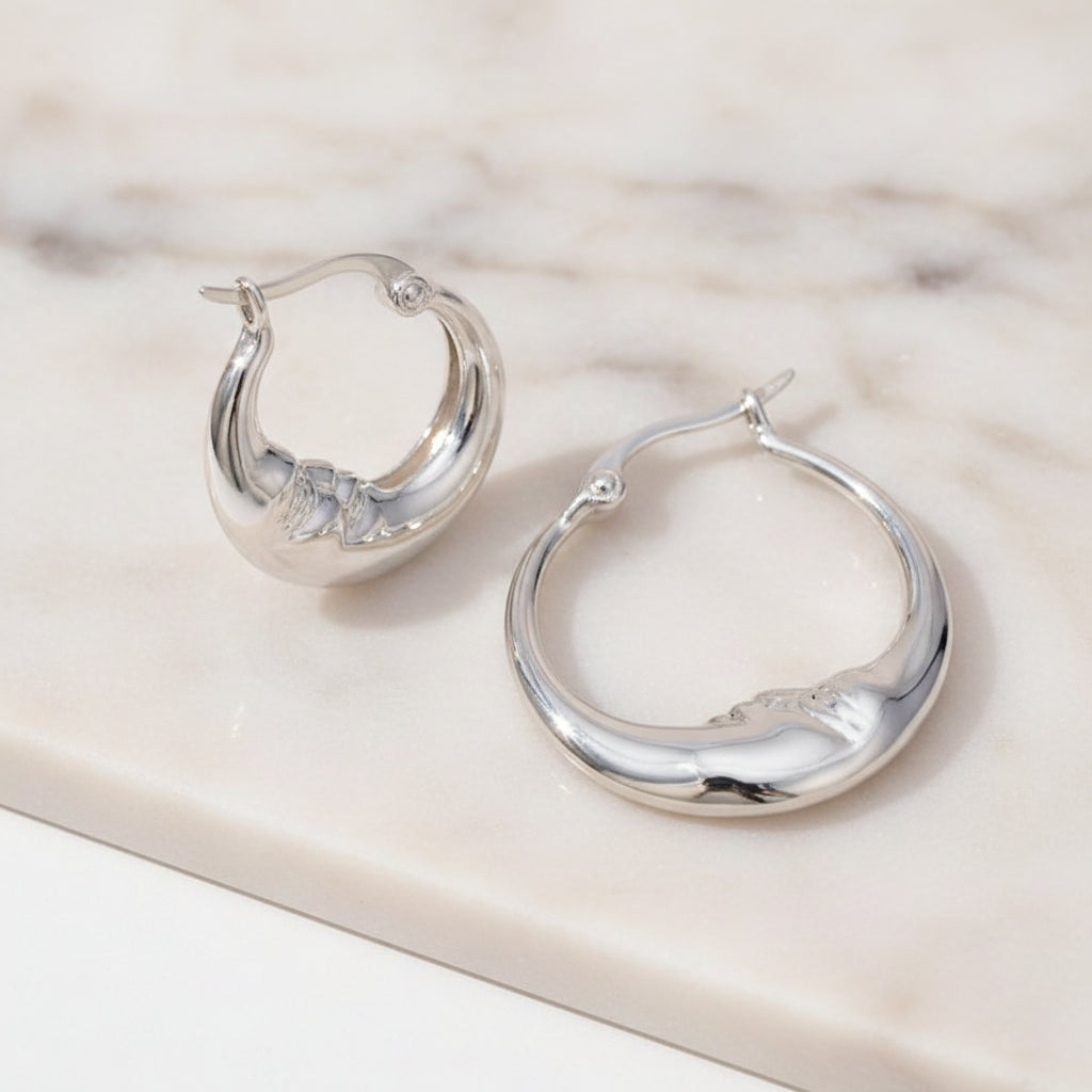 Silver hoop earrings on a white background 