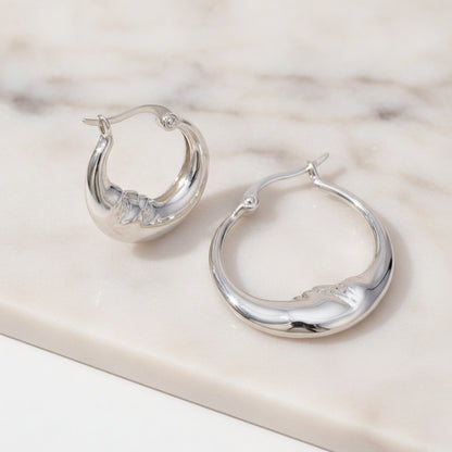 Silver hoop earrings on a white background 